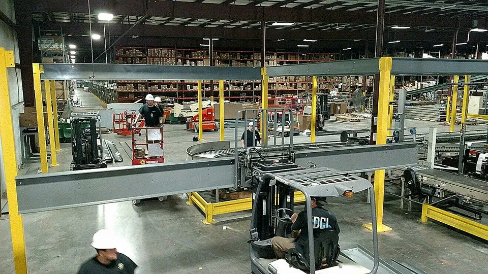 Crew safely dismantling and removing old conveyor equipment for disposal
